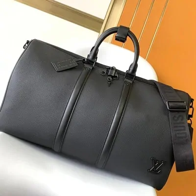A black leather weekend duffle bag with rolled leather handles