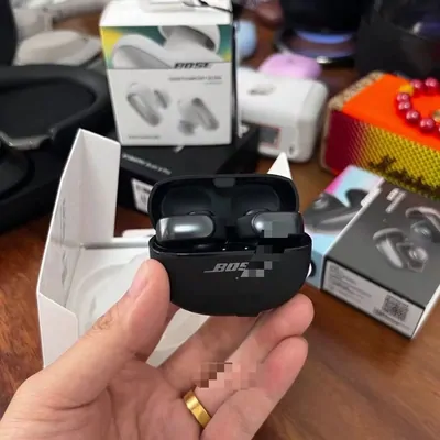 A pair of wireless earbuds held in an open charging case