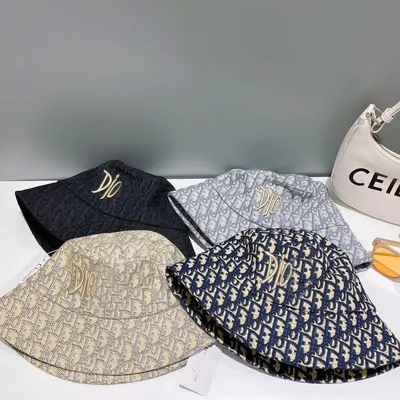 A pile of knitted beanies and patterned bucket hats