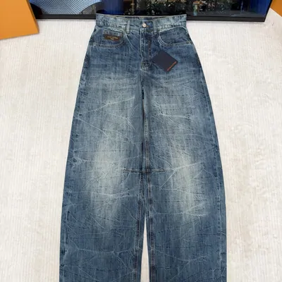 Light wash baggy jeans laid flat on a tiled floor