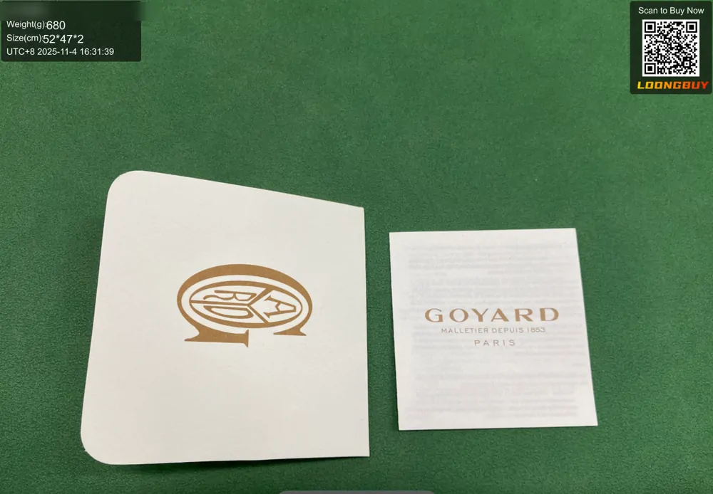 A dust bag and a printed authenticity-style card laid out on the inspection bench