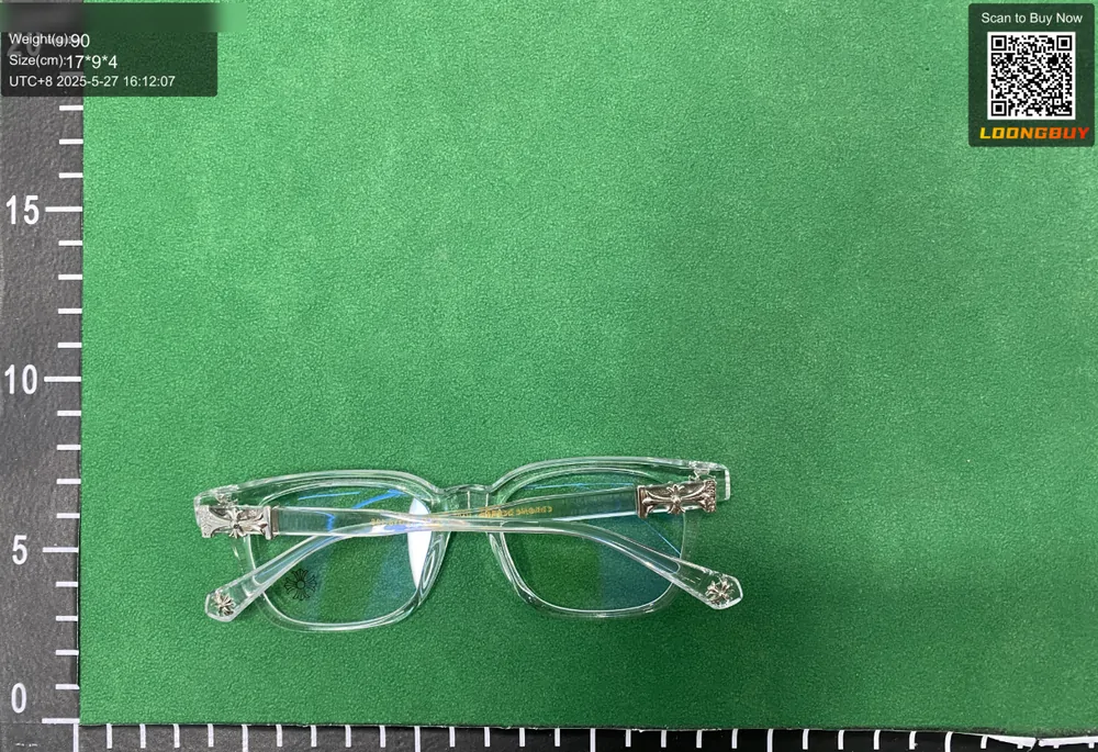 A pair of clear-framed glasses photographed at a slight angle showing the lenses and hinges
