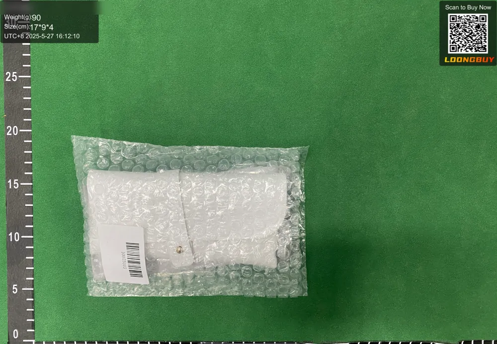 A bubble-wrapped parcel with a white shipping label on the inspection bench