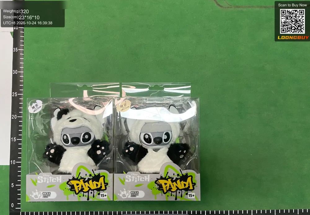 Two identical sealed plush toys side by side on the green inspection bench