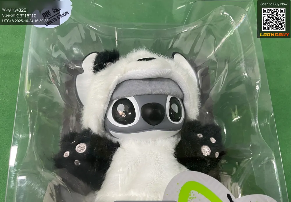 A black and white plush toy still sealed inside a clear plastic bag, photographed on a green inspection bench with the data strip visible